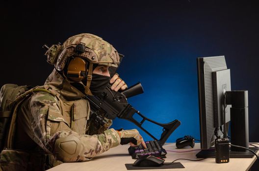 soldier sitting at a computer is conducting a cyber war