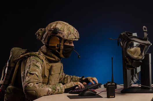 soldier sitting at a computer is conducting a cyber war