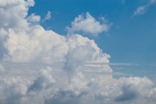 White color clouds cover the blue sky in the daytime