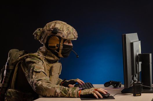 soldier sitting at a computer is conducting a cyber war