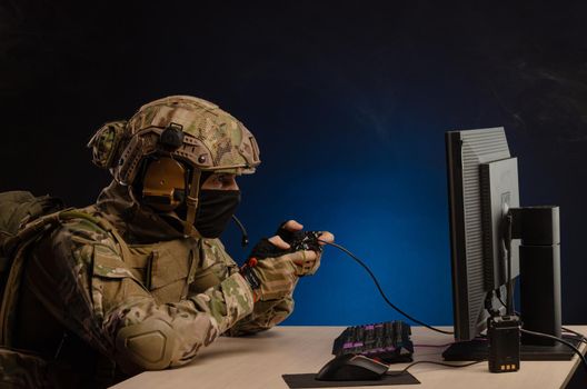 soldier sitting at a computer is conducting a cyber war