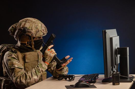 soldier sitting at a computer is conducting a cyber war