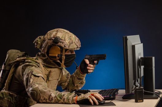 soldier sitting at a computer is conducting a cyber war