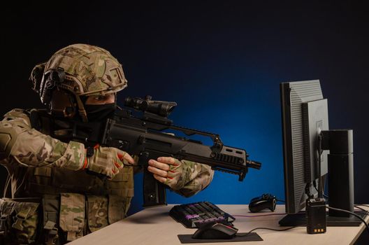 soldier sitting at a computer is conducting a cyber war