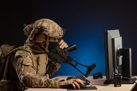 soldier sitting at a computer is conducting a cyber war