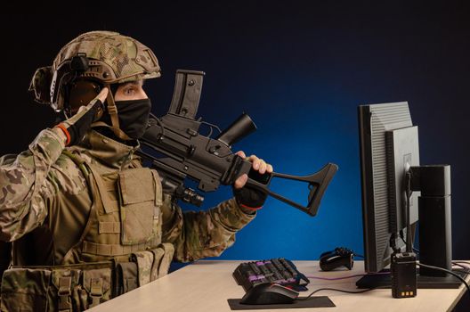 soldier sitting at a computer is conducting a cyber war