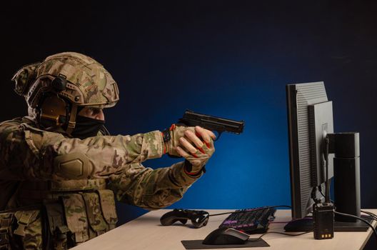 soldier sitting at a computer is conducting a cyber war