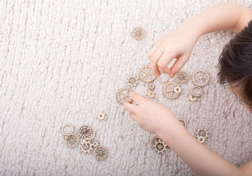 Hand holding gear wheels as the concept of mechanism