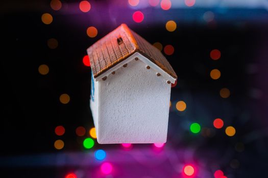 Little model house on a bokeh light background