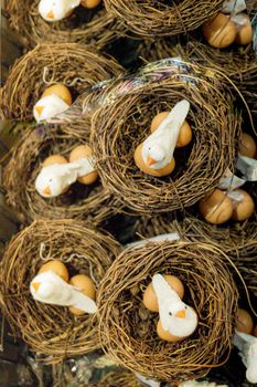 The small artificial bird nest with fake eggs in it