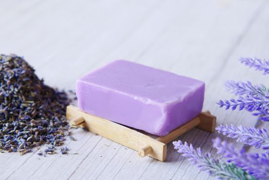 Homemade natural soap bar on black background .