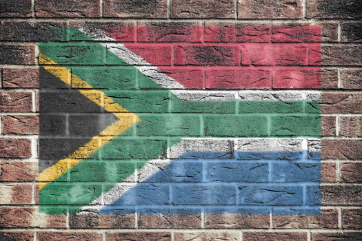 A South Africa flag on a brick wall background