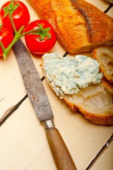 fresh blue cheese spread ove french baguette with cherry tomatoes on side