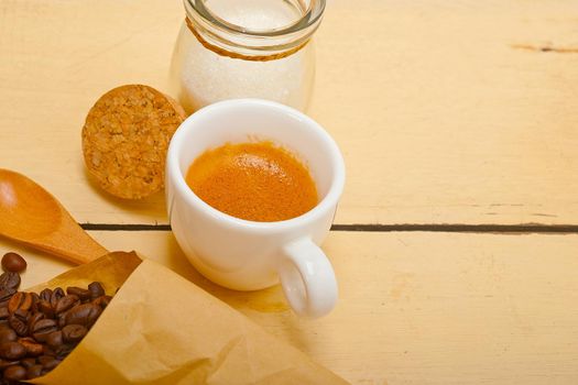 espresso coffee and beans on a paper cone cornucopia over white background