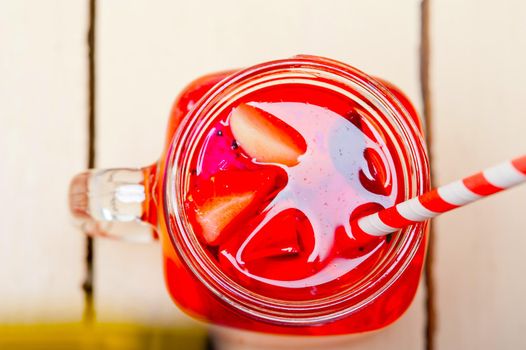 fresh fruit punch refreshing summer  drink over white rustic wood table