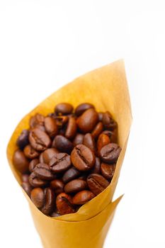 espresso coffee beans on a paper cone cornucopia over white background