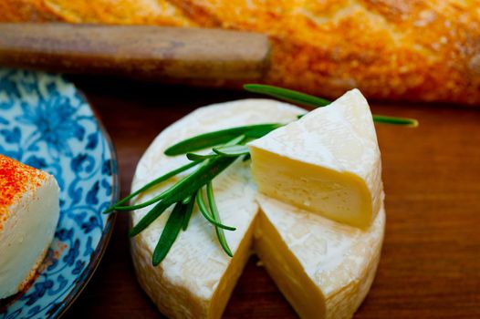 French cheese and fresh  baguette on a wood cutter