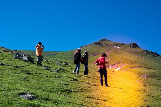 hikers with backpacks and trekking poles walking in Turkish highland