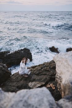 woman traveler walks volcanic rock formations on the island freedom. High quality photo