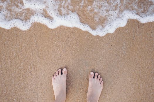 Summer vacation concept barefoot on sand at beach with copyspace background