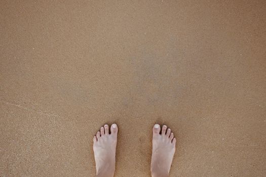 Summer vacation concept barefoot on sand at beach with copyspace background