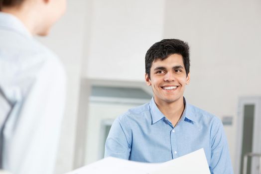 portrait of a young man at a business meeting. concept of team work