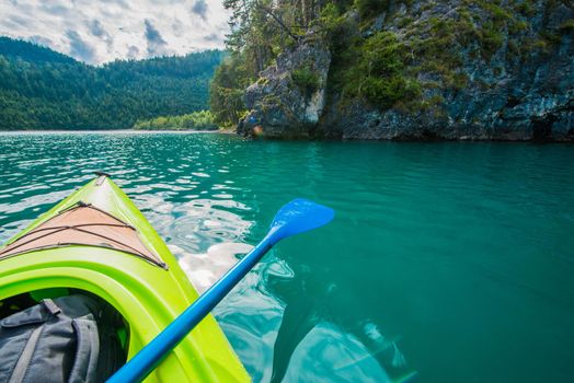 Turquoise Mountain Lake Kayaking Water Sports and Recreation. Summer Time Activity.