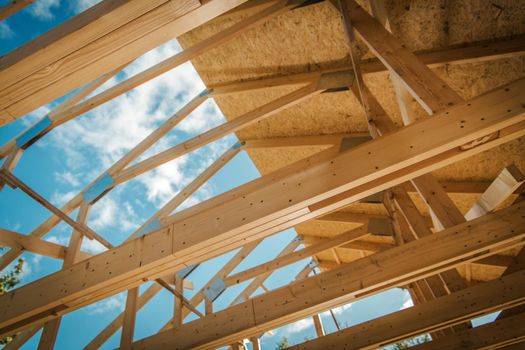 House Building. Covering Wooden Roof Structure with Plywood Boards. Closeup Photo. Construction Industry.