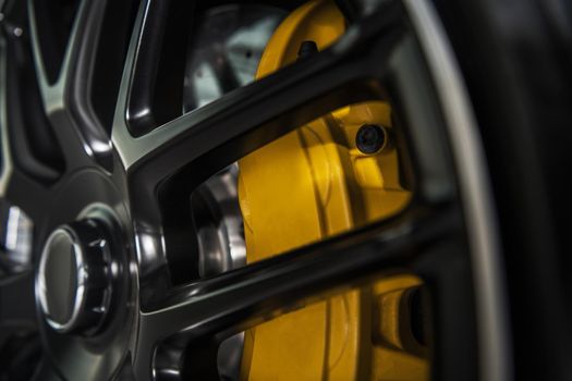 Yellow Performance Vehicle Brake Caliper Close Up. Automotive Theme.