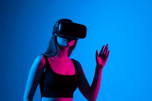 Portrait of woman video game designer wearing VR headset and interact with virtual environment or application