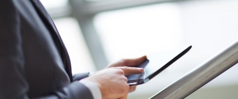 Hands of people working with a tablet computer.