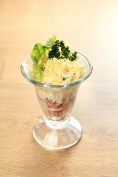 salad-cocktail with the chicken and vegetables on wooden background