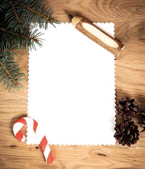 blank sheet of paper on the wooden floor with a pencil and Christmas decorations