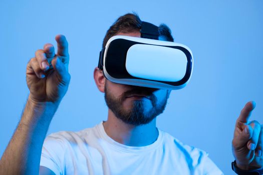Close up portrait of handsome man playing video games in 3d glasses. Player wearing virtual reality headset for smart phone on his head, smiling