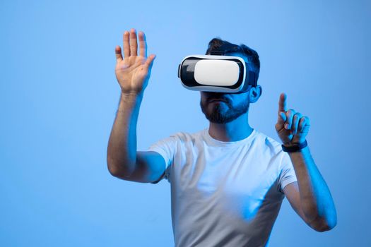 Young man developer working with a VR headset in a virtual world and create new products and applications