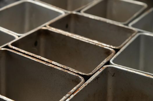 Close-up of Artisan bakery. empty filling metal bakeware.