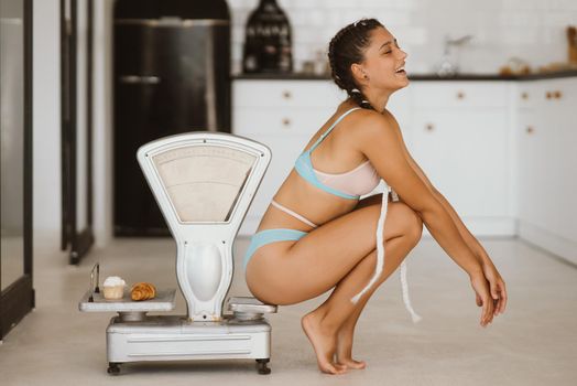 Woman in lingerie posing at the old grocery scales