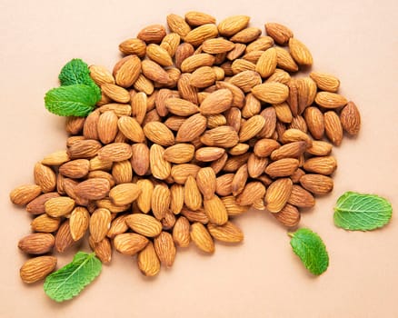 Organic almond nuts on a brown background