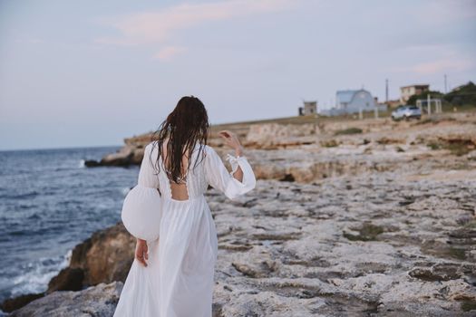woman with wet hair white dress nature walk landscape. High quality photo