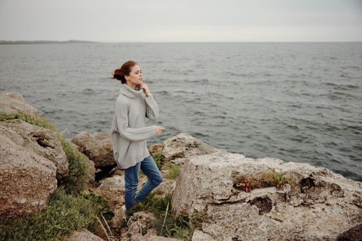 portrait of a woman beach tourism cloudy weather stone coast unaltered. High quality photo