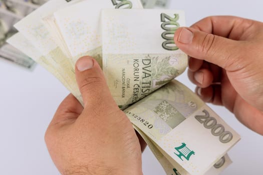 Caucasian in man holding czech koruna nominal paper banknotes