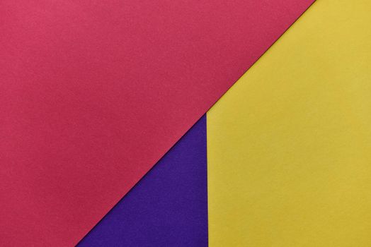 abstract geometric paper background. violet, yellow and red trendy colors. The backdrop for an invitation card, greeting card or web design. Creative copy space, flat lay.