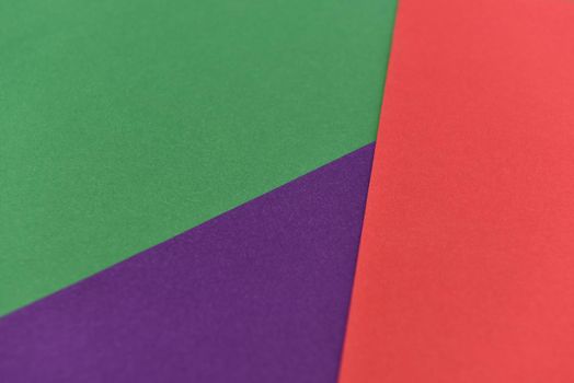 abstract geometric paper background. violet, green and red trendy colors. The backdrop for an invitation card, greeting card or web design. Creative copy space, flat lay.