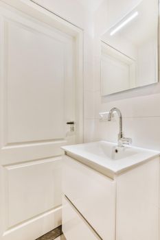 An all-white bathroom in an elegant apartment