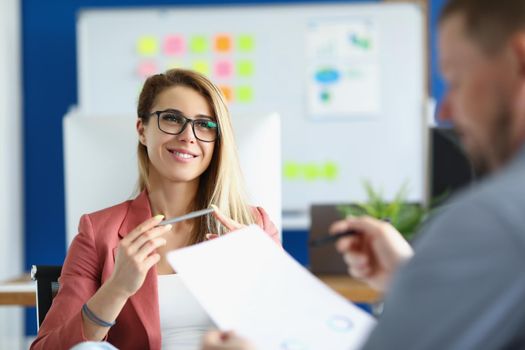 Portrait of cheerful optimistic woman listen to colleague report, office worker in suit. Woman boss proud of her worker. Business, career, strategy concept