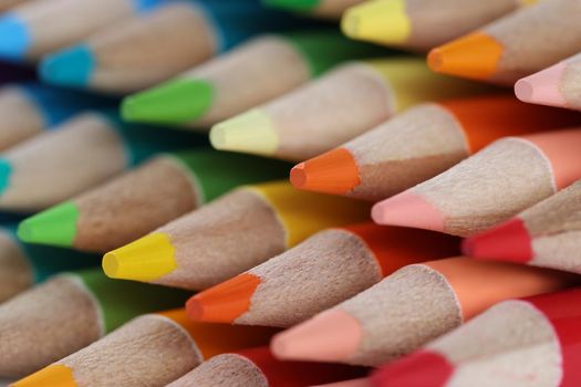 Close-up of sharpened colourful pencil set for painting forming stack. Pigmented crayons for drawing on paper. Vision, imagination, creativity, art concept