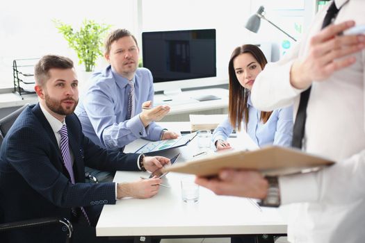 Portrait of smart man making presentation for colleagues, manager showing finance statistics to team. Company and business meeting, development concept