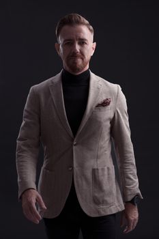 Confident businessman walking forward wearing a causal suit, handsome senior business man hero shot portrait isolated on black. High quality photo