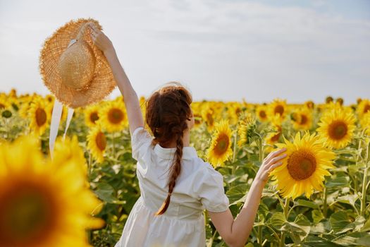 woman with pigtails in a field of sunflowers lifestyle Summer time. High quality photo