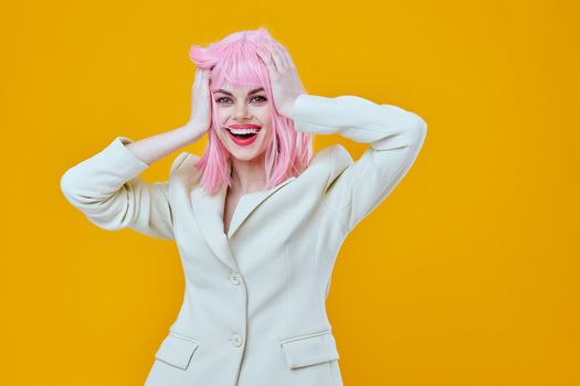 cheerful woman on yellow background with pink hair glamor. High quality photo